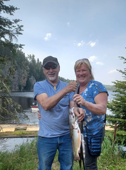 Couple souriant à la pêche à la truite à la pourvoirie Au Pays de Réal Massé